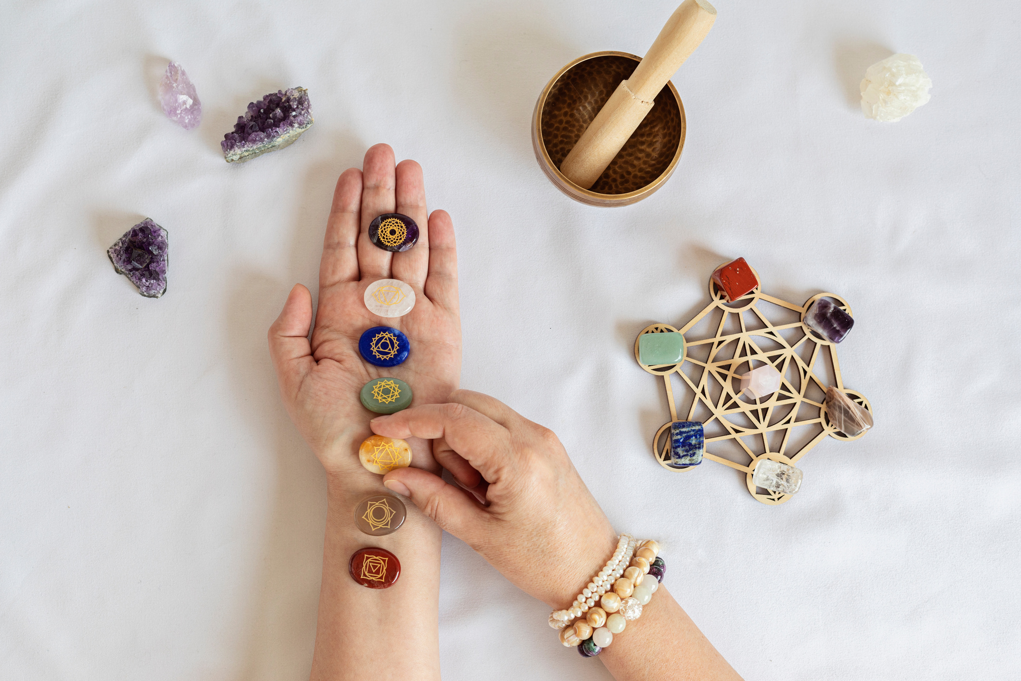 Healing reiki chakra crystals on woman's hands. Gemstones for wellbeing, meditation, relaxation